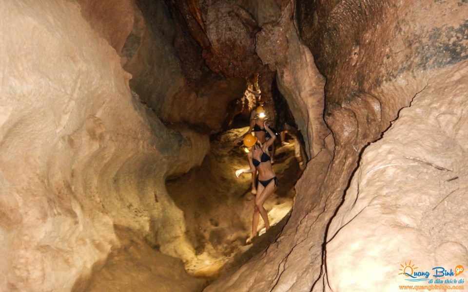 Dark cave entrance mud bath Phong Nha